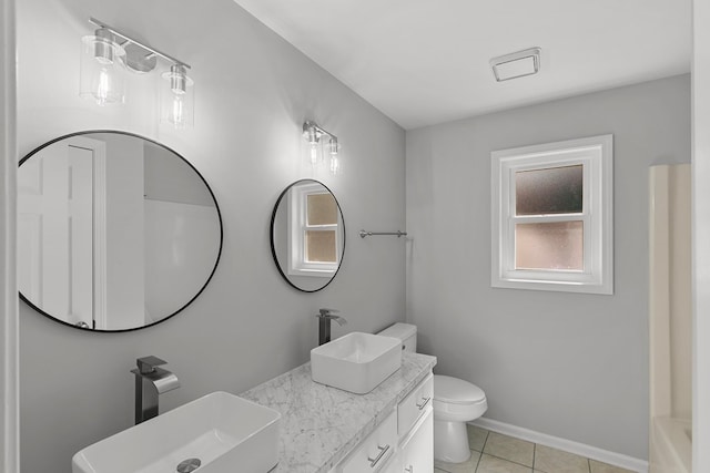 full bathroom with tile patterned flooring, toilet, baseboards, and a sink