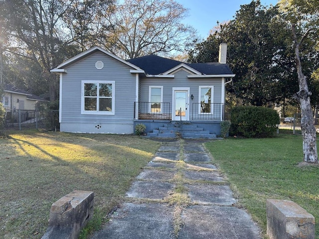 bungalow-style house with a front yard and covered porch