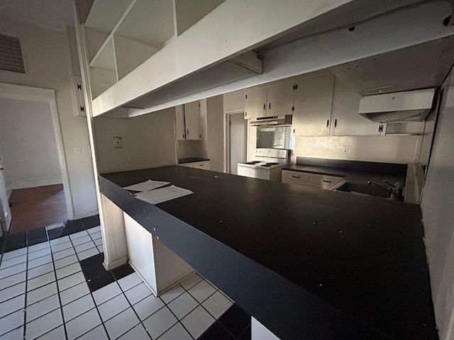 kitchen featuring light tile patterned floors, stainless steel oven, white electric range, and sink