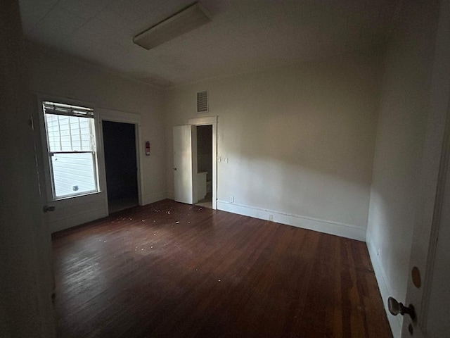 empty room featuring dark hardwood / wood-style flooring