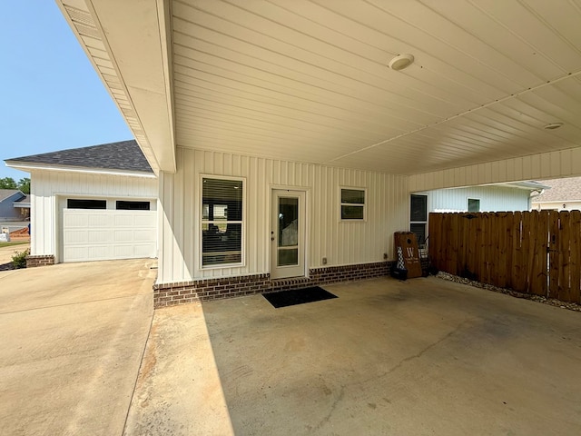 103 Neenan Dr, Enterprise, AL 36330 - property entrance featuring roof with shingles, a garage, an attached carport, and concrete driveway