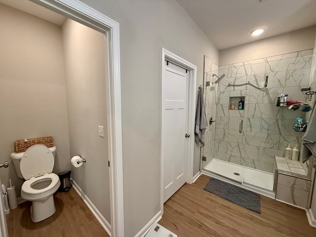 103 Neenan Dr, Enterprise, AL 36330 - full bathroom featuring wood finished floors, toilet, a marble finish shower, and baseboards