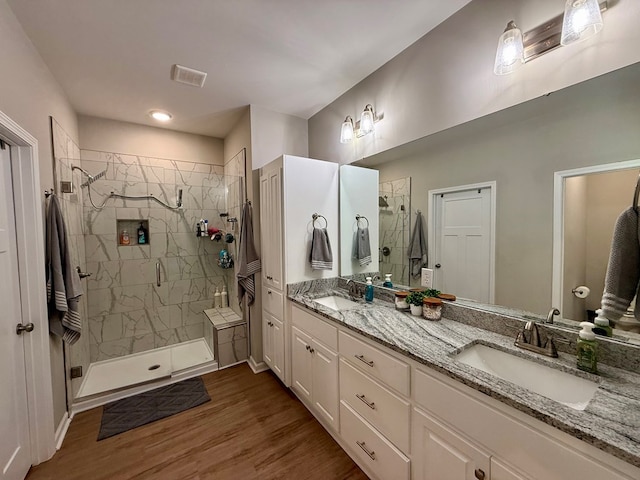 103 Neenan Dr, Enterprise, AL 36330 - bathroom featuring a stall shower, double vanity, and wood finished floors