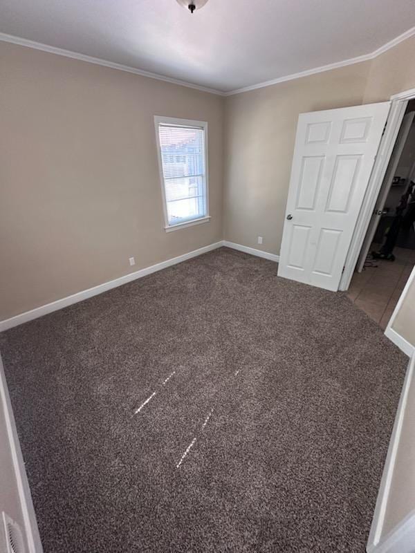 unfurnished bedroom featuring baseboards, carpet, and ornamental molding