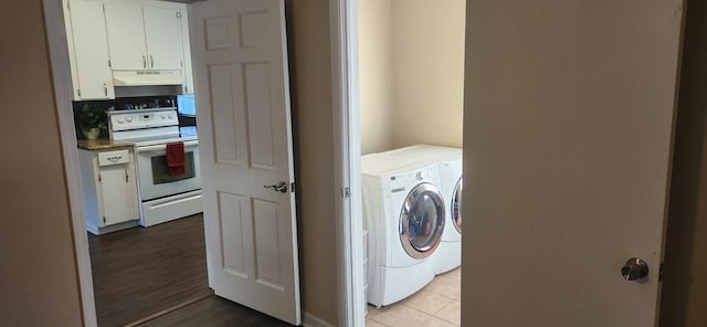 laundry room featuring washer and dryer, laundry area, and wood finished floors