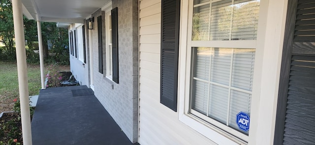 view of side of property with covered porch