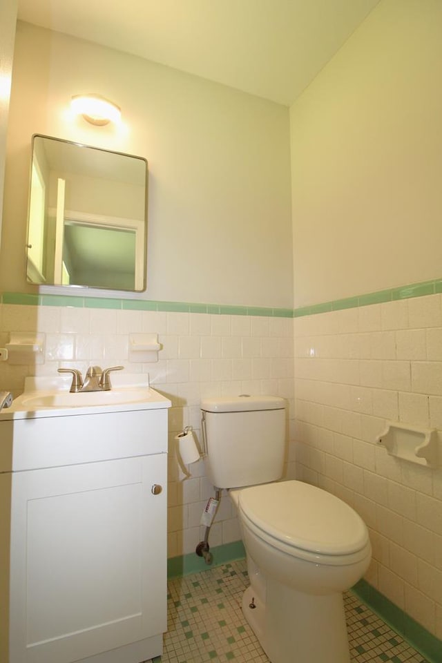 1125 Garden Ln, Dothan, AL 36301 - half bathroom with a wainscoted wall, tile patterned floors, tile walls, and vanity