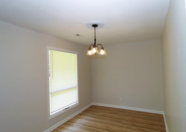 1125 Garden Ln, Dothan, AL 36301 - empty room with light wood-type flooring and a chandelier
