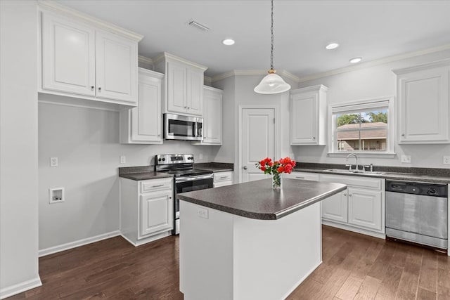 kitchen featuring white cabinetry, a center island, sink, and appliances with stainless steel finishes