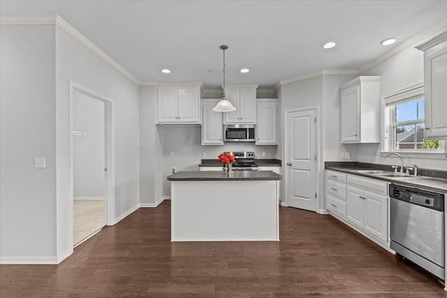 kitchen featuring a center island, dark wood-type flooring, white cabinets, sink, and stainless steel appliances