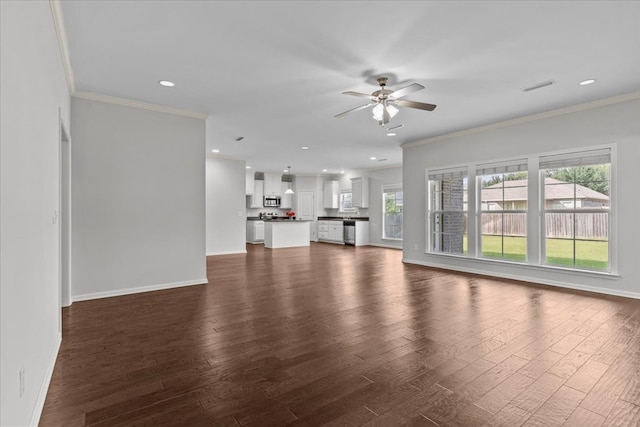 unfurnished living room with ceiling fan, crown molding, and dark wood-type flooring