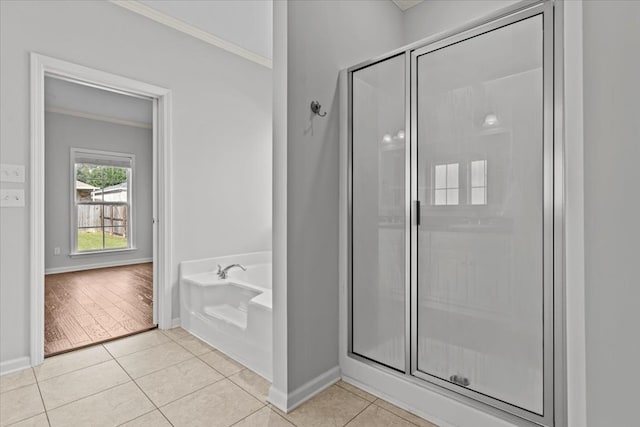 bathroom with hardwood / wood-style flooring, ornamental molding, and shower with separate bathtub