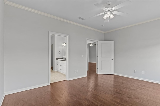 unfurnished bedroom featuring connected bathroom, light hardwood / wood-style floors, ceiling fan, and crown molding