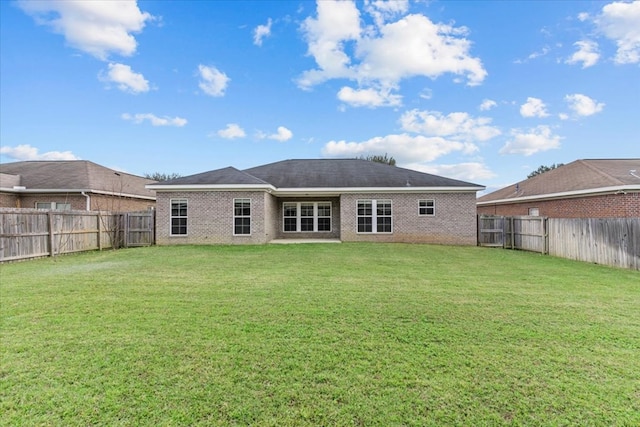 rear view of property featuring a yard