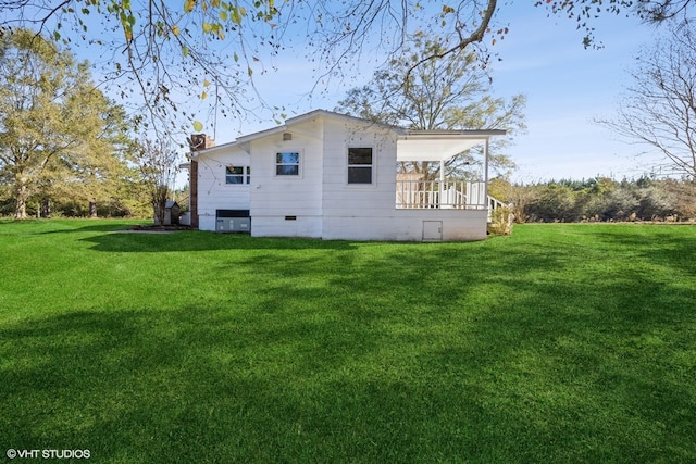 rear view of house with a yard