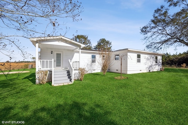 back of house featuring a lawn and a porch