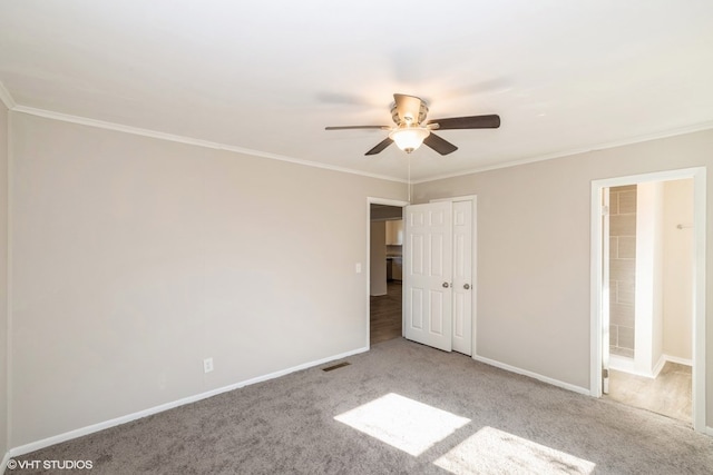 unfurnished bedroom featuring carpet, ceiling fan, and ornamental molding