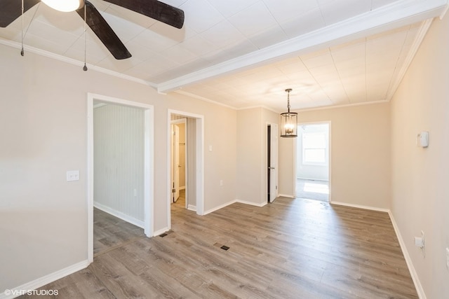 spare room featuring crown molding, ceiling fan, and wood-type flooring