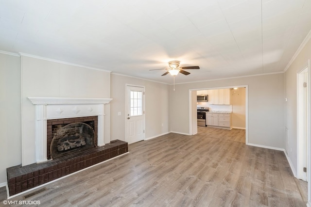 unfurnished living room with a fireplace, light hardwood / wood-style flooring, ceiling fan, and ornamental molding