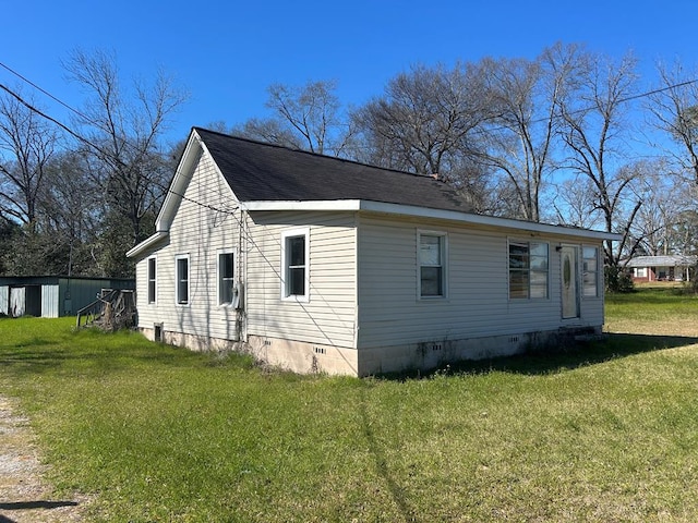 view of property exterior featuring a shingled roof, crawl space, and a yard