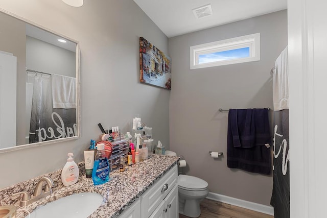 bathroom with vanity, wood-type flooring, and toilet