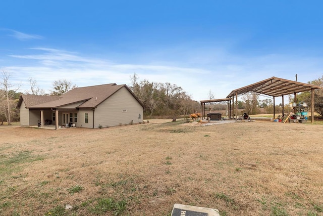 view of yard featuring a pergola and a playground