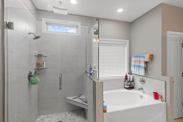 bathroom featuring separate shower and tub