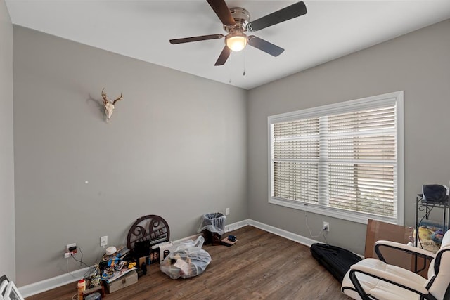 living area with hardwood / wood-style floors and ceiling fan