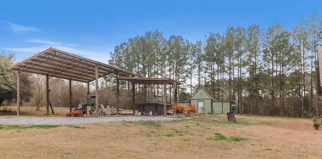 view of yard featuring a carport and a storage unit