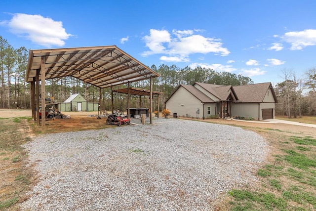 view of vehicle parking featuring a carport and a garage