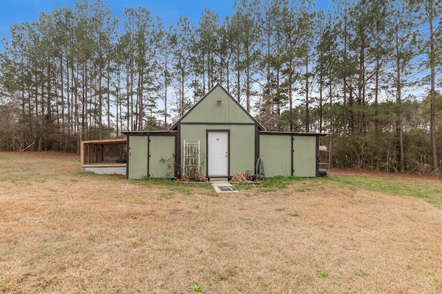 view of outdoor structure featuring a lawn