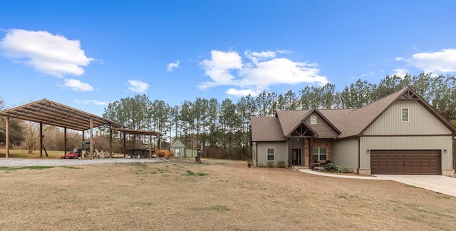 view of front facade featuring a shed, a garage, a front yard, and a carport