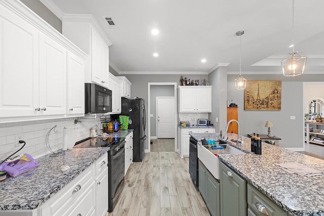 kitchen featuring pendant lighting, white cabinetry, sink, light stone counters, and black appliances