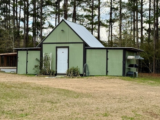 view of outbuilding featuring a lawn