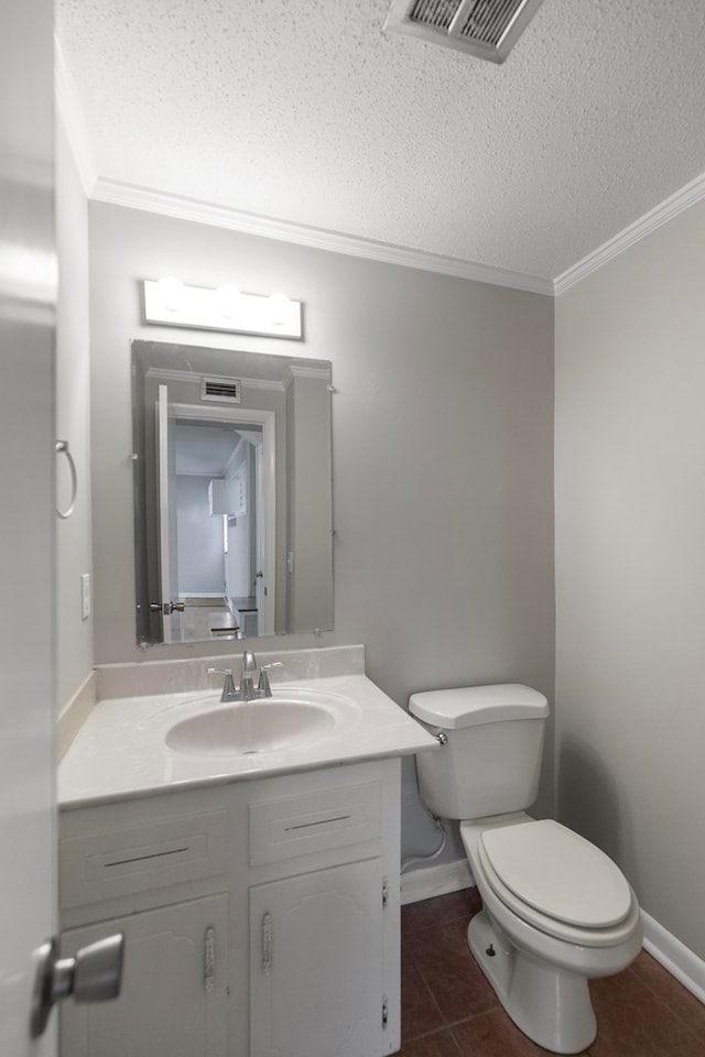 bathroom with vanity, toilet, tile patterned flooring, and a textured ceiling