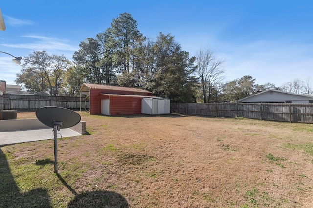 view of yard with central AC and a storage unit