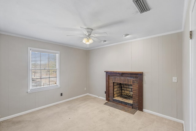 unfurnished living room with ceiling fan, ornamental molding, light carpet, and a brick fireplace