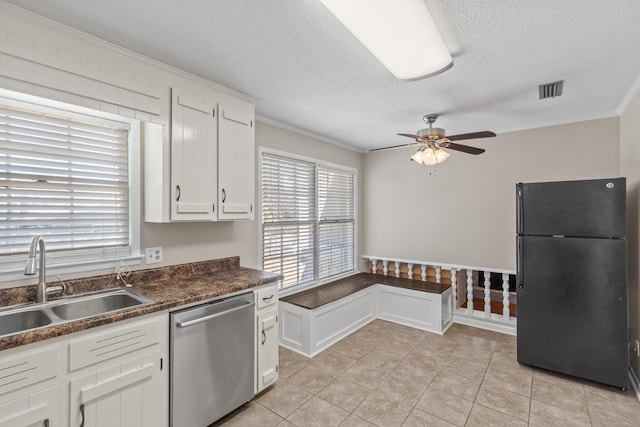 kitchen featuring sink, dishwasher, white cabinets, a textured ceiling, and black fridge