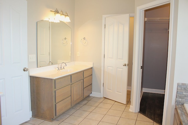 105 Frisco Ln, Enterprise, AL 36330 - bathroom with tile patterned floors, baseboards, vanity, and a walk in closet