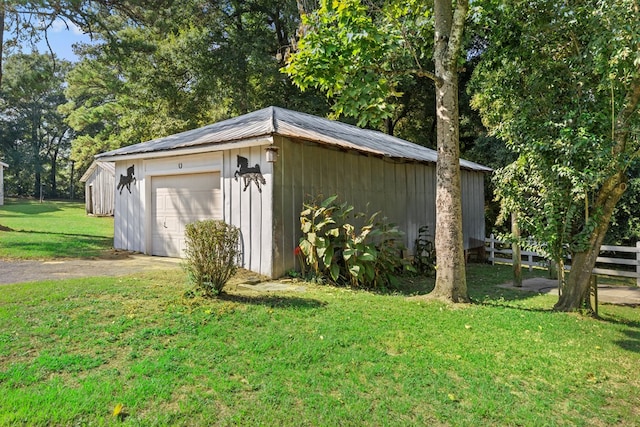 view of outbuilding featuring a yard and a garage