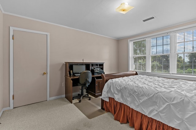 carpeted bedroom featuring crown molding