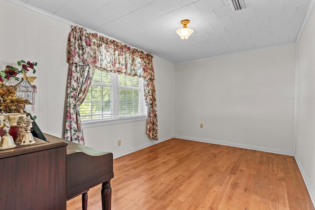 bedroom with light hardwood / wood-style flooring and ornamental molding