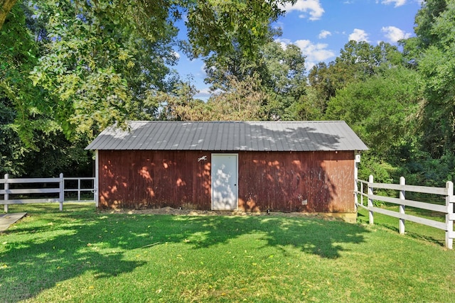 view of outbuilding with a lawn