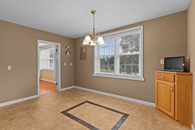 unfurnished dining area featuring a notable chandelier