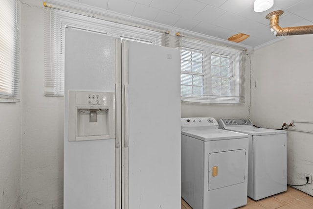 clothes washing area featuring light tile patterned floors, ornamental molding, and independent washer and dryer