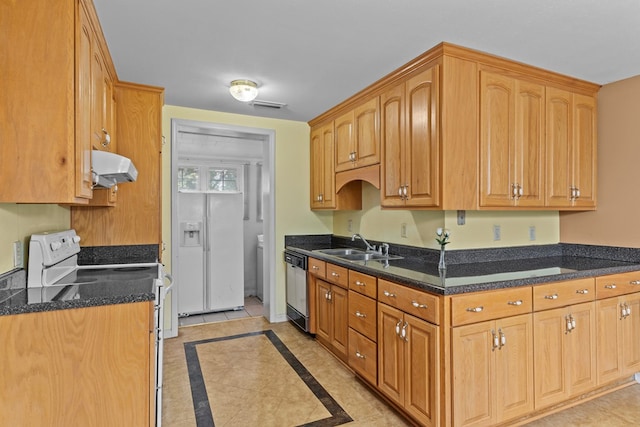 kitchen featuring dishwasher, sink, range hood, white range with electric cooktop, and dark stone countertops