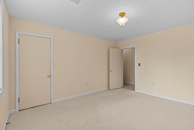 unfurnished room with light carpet