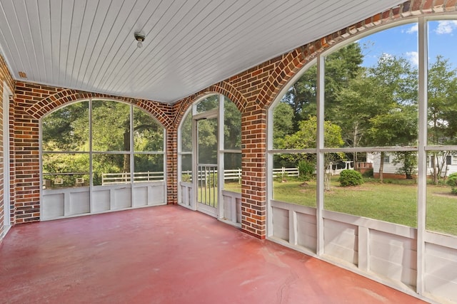 unfurnished sunroom with wooden ceiling