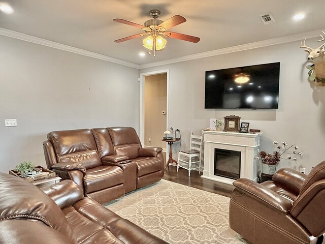 1243 Silcox Rd, Ashford, AL 36312 - living area featuring ornamental molding, ceiling fan, wood finished floors, a glass covered fireplace, and recessed lighting