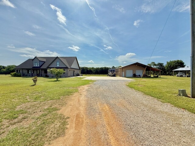1243 Silcox Rd, Ashford, AL 36312 - view of front facade featuring a detached garage, dirt driveway, a front yard, and an outdoor structure